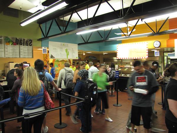 Dining hall busy with students getting food.