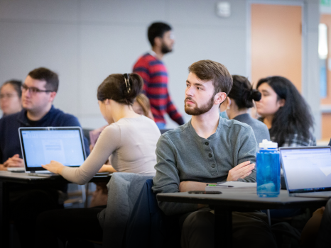 Students sitting in a classroom listening to speaker.