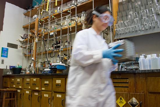 woman in lab coat works in a lab