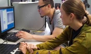 people work intently on computers